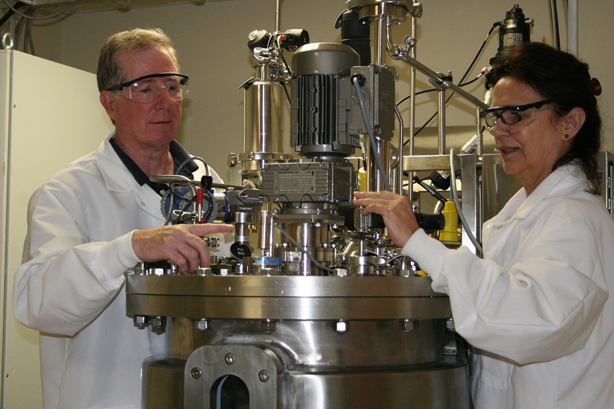 Assoc. Prof. Carl Lawton and a researcher use the bioreactor at the Massachusetts Biomanufacturing Center at UMass Lowell
